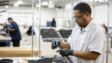 Ford factory operators and assemblers assemble medical face shields
