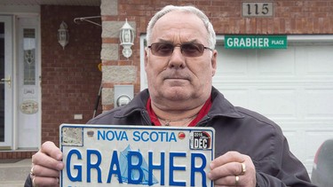 Lorne Grabher displays his personalized licence plate in Dartmouth, N.S. on Friday, March 24, 2017. A Nova Scotia man plans to file an appeal of a court ruling that upheld the province's decision to revoke a licence plate personalized with his surname — Grabher.