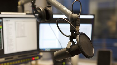 Studio microphone in front of radio station broadcasting equipment