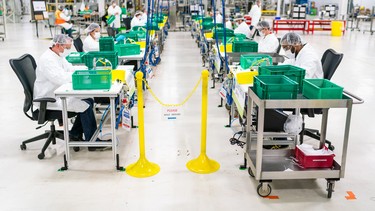 Workers begin final preparation for manufacturing Level 1 face masks Wednesday, April 1, 2019 at the General Motors facility in Warren, Michigan.