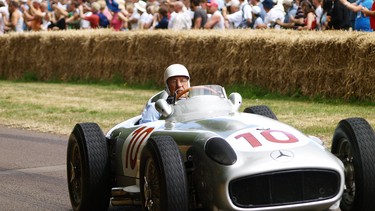 In this file photo taken on July 5, 2009, Britain's Stirling Moss drives his 1954 Mercedes Benz W196 racing car past the crowds at Goodwood's Festival of Speed in Goodwood, Southern England.