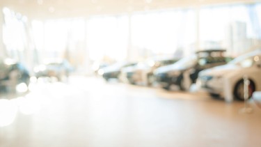 Abstract background of blurred  new cars dealership place