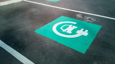 Electric car charging point parking with blue signs