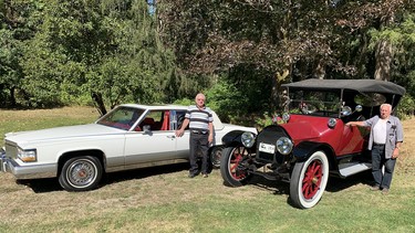 Neighbours Tom King and George Hoffman display their 1990 and 1914 models illustrating the evolution of Cadillac motor cars over a 75-year period.