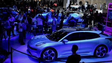 People look at the Lynk & Co Zero concept car displayed at the Beijing Auto Show in Beijing on September 26, 2020.