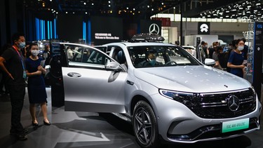 Visitors try the Mercedes Benz EQC 400 car at the Beijing Auto Show in Beijing on September 27, 2020.