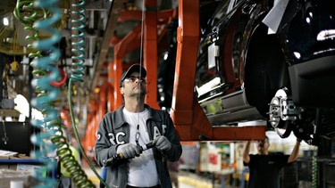 A Ford employee works on the line at an assembly facility June 3, 2008 in Oakville, Canada.