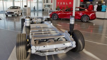 A cutaway of the chassis of a Tesla Model S in a showroom