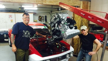 Richard Nyberg, left, had help from his friend Dedalo Pereira to install the engine in his 1973 Alfa Romeo GTV; he’s since sold that completed car.