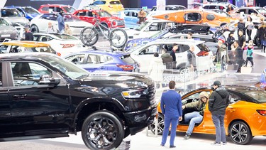 Spectators check out new vehicles at the Canadian International Auto Show in Toronto