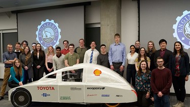 The University of Alberta engineering students who are part of the EcoCar team stand around their named EcoCar named Kate. Image supplied