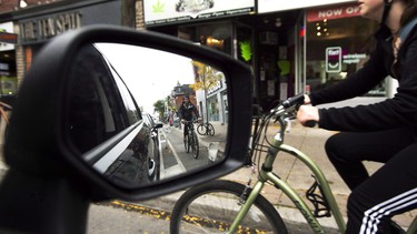 Cyclists ride on the designated Bloor Street bike lanes in Toronto on Thursday, October 12, 2017.