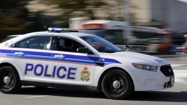 Lights and siren on, an Ottawa police cruiser vehicle races to a call.