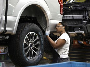 A Ford Motor Company worker works on a Ford F-150 truck on the assembly line at the Ford Dearborn Truck Plant on September 27, 2018 in Dearborn, Michigan.