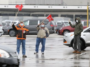 Unifor Local 444 members react to passing motorists while maintaining their presence at Windsor Assembly Plant's Walker Road shipping gate during a labour dispute involving the union and Motipark Sunday.