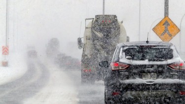 Visibility was limited on Highway 20 through the St-Pierre Interchange during a snowstorm in Montreal on Feb. 2, 2021.