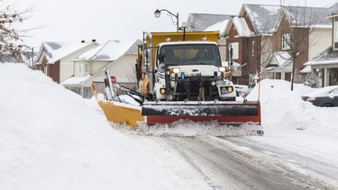 A snowplow doing what snow plows do.