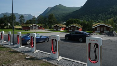 Tesla cars stand at a Tesla Supercharger charging station on August 12, 2020 in Skei, Norway.