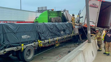 This image released by the Fort Worth Fire Department Public Information Office on their Twitter feed (@FortWorthFire) shows firemen reaching out to drivers following a major car crash caused by the icy weather on Interstate 35 near Fort Worth, Texas on February 11, 2021.