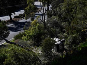 The vehicle driven (R bottom) by golfer Tiger Woods lies on its side in Rancho Palos Verdes, California, on February 23, 2021, after a rollover accident.