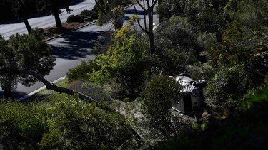 The vehicle driven (R bottom) by golfer Tiger Woods lies on its side in Rancho Palos Verdes, California, on February 23, 2021, after a rollover accident.