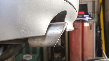 The exhaust system in the diesel car seen up close, view from rear of muffler.