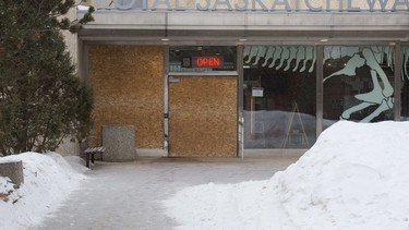 A door and a window can be seen boarded up at the Royal Saskatchewan Museum in Regina, Saskatchewan on Feb. 17, 2021. The Regina Police Service says a man crashed a vehicle into the museum on Tuesday evening and they anticipate charges to be laid in relation to the matter.