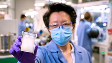 A GM employee poses with an example of the company's next-generation lithium metal batteries at  GM Chemical and Materials Systems Lab in Warren, Michigan, U.S. September 9, 2020. Picture taken September 9, 2020.   Steve Fecht/General Motors/Handout via REUTERS. THIS IMAGE HAS BEEN SUPPLIED BY A THIRD PARTY. NO RESALES. NO ARCHIVES