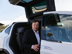 Tesla CEO Elon Musk gets back into his Tesla after talking to media before visiting the construction site of the future US electric car giant Tesla, on September 03, 2020 in Gruenheide near Berlin.