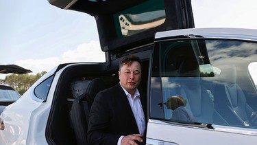 Tesla CEO Elon Musk gets back into his Tesla after talking to media before visiting the construction site of the future US electric car giant Tesla, on September 03, 2020 in Gruenheide near Berlin.
