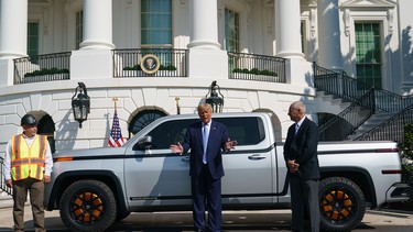 US President Donald Trump (C) speaks while next to Lordstown Motors CEO Steve Burns (R) in front of the Endurance pickup truck on the south driveway of the White House in Washington, DC on September 28, 2020.