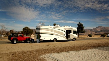 An RV camper 'dinghy'-towing a Jeep