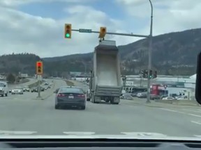 WATCH- Kelowna dump truck driver smashes green lights with box raised