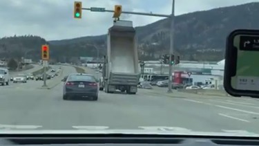 WATCH- Kelowna dump truck driver smashes green lights with box raised