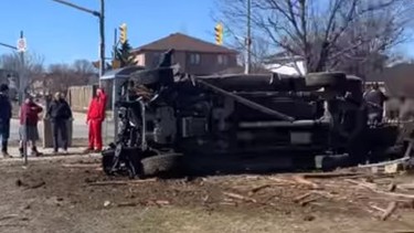 A pickup truck lays on its side after a crash in a residential area of Barrie on Saturday, March 14, 2021.