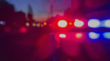 Red and blue Lights of police car in night time. Night patrolling the city. Abstract blurry image.