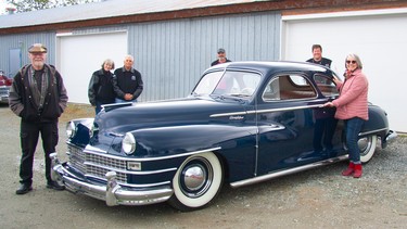 Saanich Peninsula Hospital Foundation executive director Karen Morgan with members of the Torque Masters Car Club that restored the 1947 Chrysler coupe to enhance the lives of dementia patients.