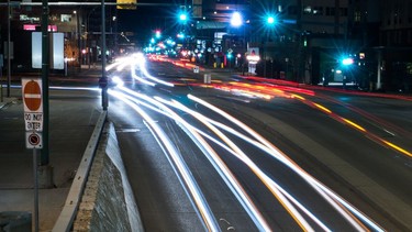 A long exposure shows the blurred lights of vehicles as they travel along Broad Street in Regina, Saskatchewan on May 2, 2020.