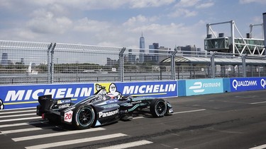 Mitch Evans pilots his Jaguar I-TYPE during the 2019 New York City ePrix in Brooklyn with the Manhattan skyline in the background.