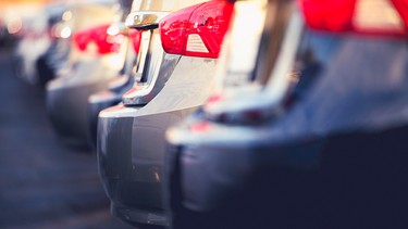 Close up photo of cars for sale lined up in parking lot.