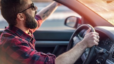 Angry young man gesturing and shouting at other drivers on the road rage traffic anger