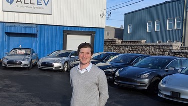 Jérémie Bernardin with some of the used EVs on the lot  at the All EV Canada dealership in Dartmouth, Nova Scotia.