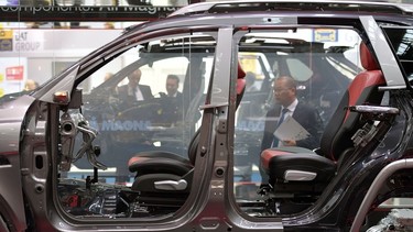 A visitor looks to a car model with components of the auto parts manufacturer 'Magna' at the 2017 Frankfurt Auto Show 'Internationale Automobil Ausstellung' (IAA) on September 13, 2017 in Frankfurt am Main, Germany.