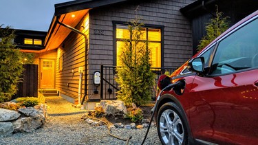 A Chevrolet Bolt charges up outside a cabin in Port Renfrew, B.C.