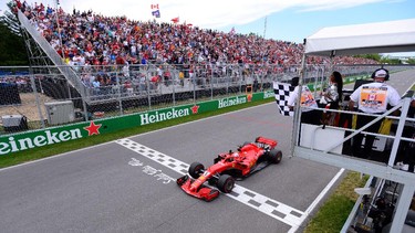 FILE PHOTO: Formula One F1 - Canadian Grand Prix - Circuit Gilles Villeneuve, Montreal, Canada - June 10, 2018   Ferrari's Sebastian Vettel passes the chequered flag to win the race