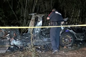 The remains of a Tesla vehicle are seen after it crashed in The Woodlands, Texas, April 17, 2021, in this still image from video obtained via social media.