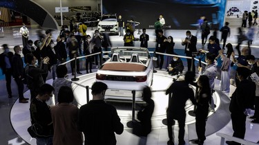 No, those aren't avatars checking out the Wuling Hongguang Mini convertible electric vehicle during the media day of the 2021 Shanghai Auto Show. Motor Corp., General Motors Co. (GM) and Liuzhou Wuling Motors Co., at the Auto Shanghai.