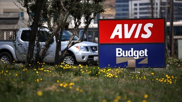 A sign is posted in front of an Avis Budget rental car office on July 28, 2020 in South San Francisco, California.