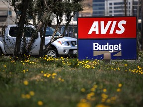 A sign is posted in front of an Avis Budget rental car office on July 28, 2020 in South San Francisco, California.