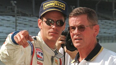 Three-time Indianapolis 500 winner Bobby Unser (right of photo) talks with his son, rookie Indy car driver Robby Unser, during the second day of practice 11 May for the 82nd Indianapolis 500.